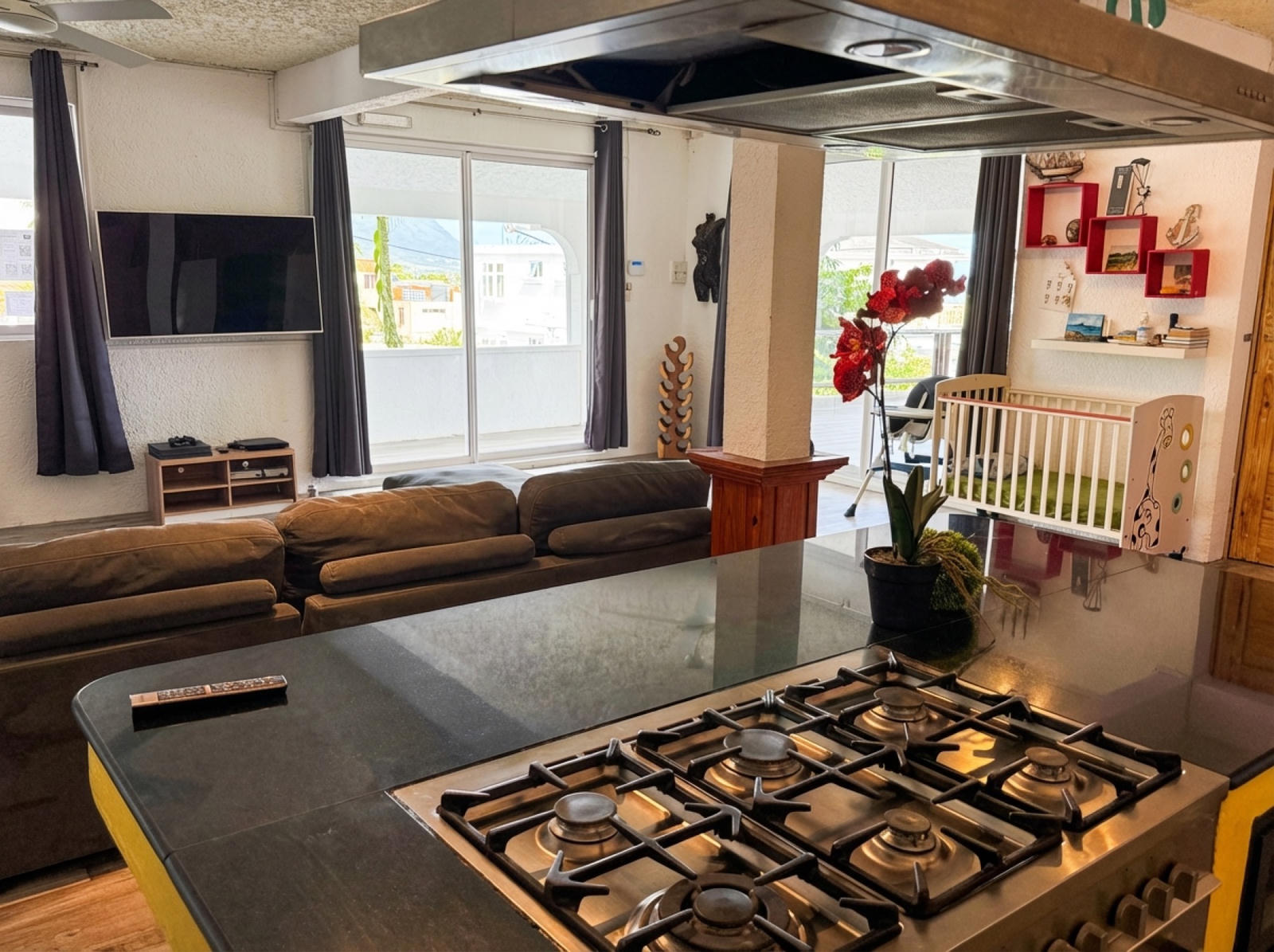 Gas stove island opening to living area and terrace with Le Morne view
